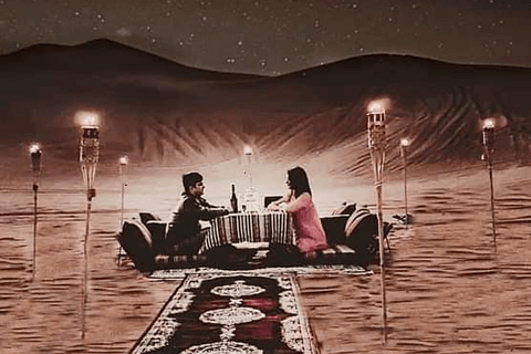 A couple sitting on a rug in the desert, enjoying the serene landscape and each other's company.