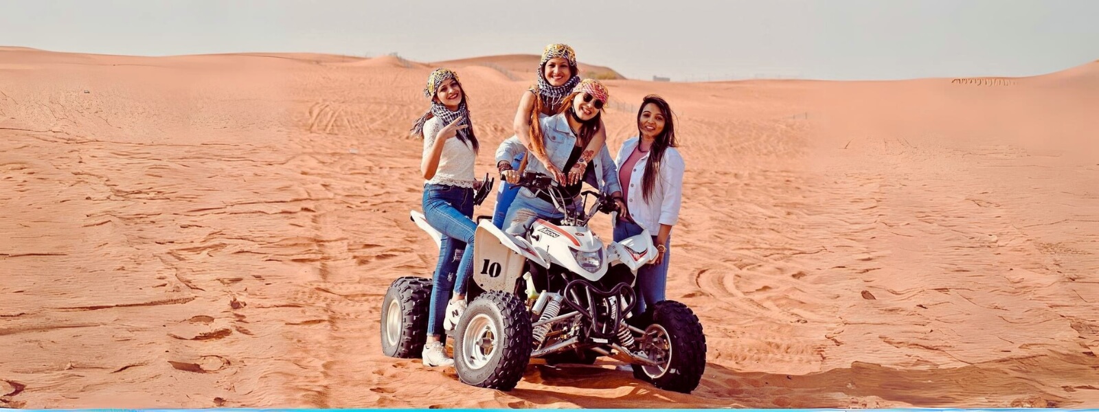 Three people riding ATV bikes in the desert, experiencing an adventurous and thrilling journey.