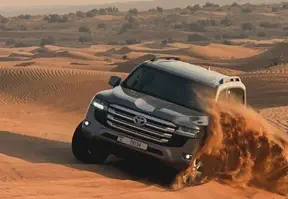 A Land Cruiser confidently traversing the desert sands, showcasing its off-road capabilities.