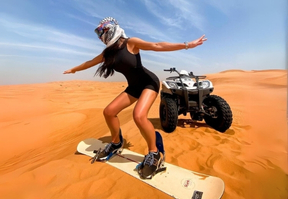 A woman sandboarding in the desert, defying expectations with her adventurous spirit.